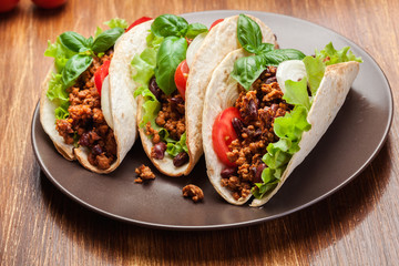 Mexican tacos with minced meat, beans and spices