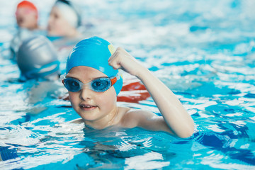 Wall Mural - young and successful swimmers pose