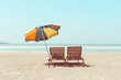 © nevodka.com - Vintage toned two beach chairs and umberella on empty tropical ocean beach at sunny day