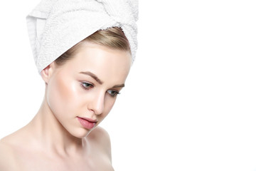 Wall Mural - beautiful young blond woman with perfect skin and her hair wrapped in a towel. cosmetology, beauty a