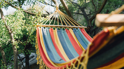 Wall Mural - Close-up color travel hammock for relaxing in the trees. Stay in the journey on the hammock