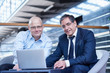 © Connect Images - Portrait of two mature businessmen meeting on office balcony