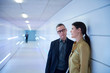 © Connect Images - Businesswoman and man talking in office corridor