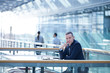 © Connect Images - Portrait of businessman sitting at office balcony table