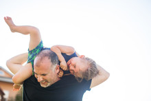 Father And Son Fooling Around, Outdoors, Father Carrying Son Over Shoulders