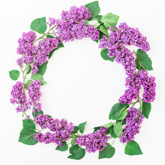  Floral round frame of lilac branches and leaves on white background. Flat lay, top view. Summer pattern