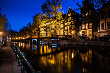 Wall Mural - Night shot of Amsterdam canal city view with bicycles on the bridge, Netherlands