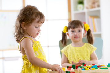 Poster - children learning to sort shapes in kindergarten or daycare center