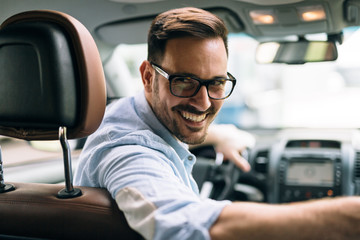 Portrait of a handsome businessman driving car