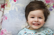 © alexkich - Portrait of a young child lying on a pillow