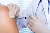 Fototapeta Młodzieżowe - Doctor making a vaccination