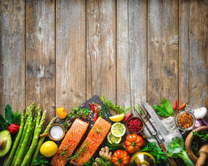 Wall Mural - Fresh salmon fillet with aromatic herbs, spices and vegetables