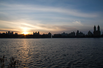 Wall Mural - Sunset reflects on the lake and buildings