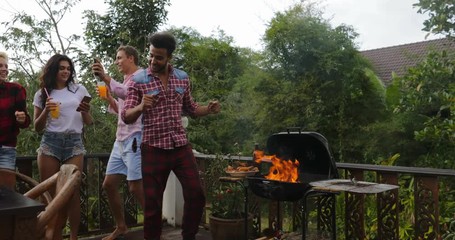 Wall Mural - young people dancing cooking barbecue friends group cheerful gathering on summer terrace having part