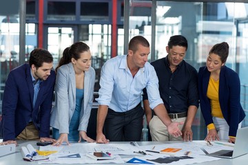 Wall Mural - Businesspeople having discussion over document