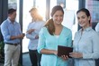 © wavebreak3 - Portrait of businesswomen using digital tablet