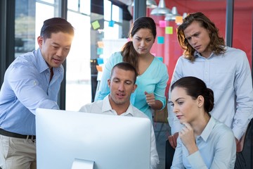 Wall Mural - Businesspeople having discussion over personal computer