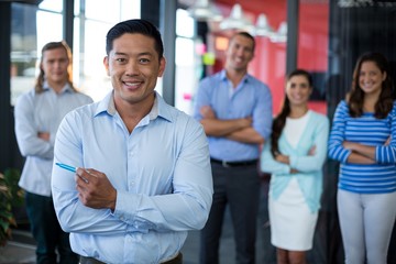 Wall Mural - Portrait of businesspeople standing with arms crossed