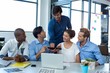 © wavebreak3 - Team of graphic designers discussing over digital tablet