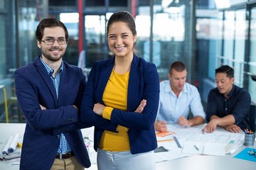 Wall Mural - business executive smiling while colleague interacting