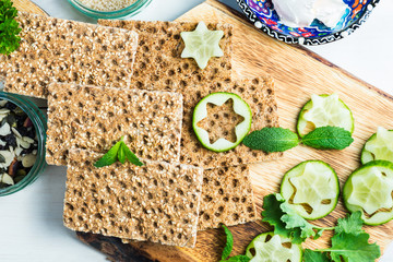 Wall Mural - Snack from Wholegrain Rye Crispbread Crackers and Cucumber