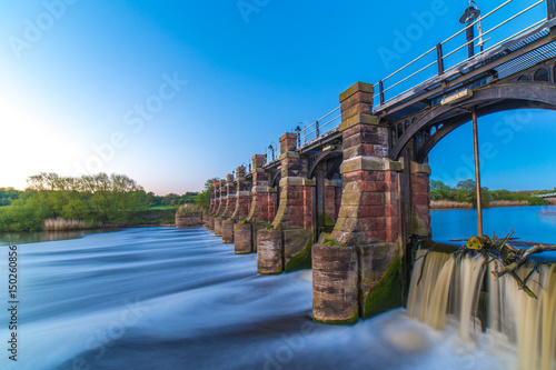 Fotomural River weaver sluice gates Northwich Cheshire UK at sunset