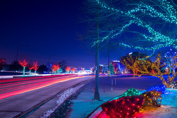 Wall Mural -  Cityscape night with car’s stoplight trails and Christmas lights
