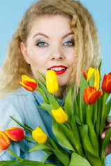 Pretty woman with red yellow tulips bunch