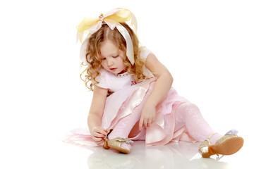 little girl trying on shoes.
