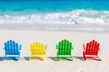 Wall Mural - Beach chairs on the sandy beaches for tourists to sit and relax in the soft ocean waves breaking on the beach. Made of paper.