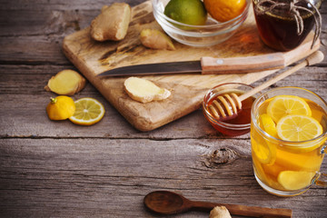 Wall Mural -  Ginger tea and ingredients on a  grunge wooden background