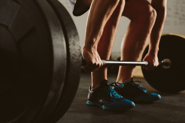 Wall Mural - Weightlifter doing barbell workout at gym