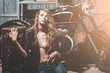 Sexy girl model in unbutton shirt sitting on garage floor