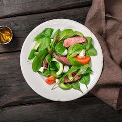 Wall Mural - Salad of spinach leaves and grilled beef meat