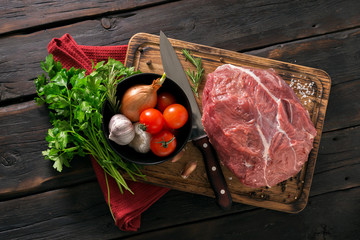 Wall Mural - Fresh beef tenderloin with vegetables on kitchen board