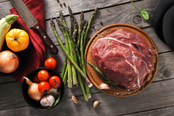 Canvas Print - Fresh beef tenderloin on cutting board with different  vegetables