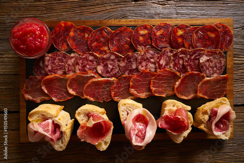 Fotografía Iberian sausages ham board Tapas from spain