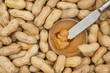 Peanut butter and raw peanuts in shells