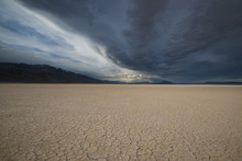 Usa, Oregon, Alvord Desert. Approaching Rain Storm And Clouds Over The Parched Mud Patterns
