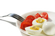 © Nadia - Chicken boiled eggs on a white plate with slices of red tomato on a white background