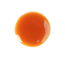 Wall Mural - Delicious caramel sauce on white background