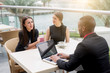 © Dusan Petkovic - Smiling business people having an outdoor meeting. Successful brainstorming.