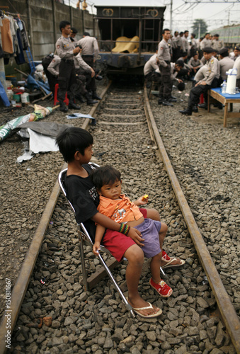 Children Are Pictured Sitting On A Chair During An Eviction