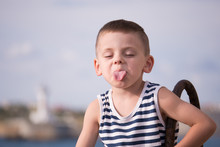 Funny Boy In Sailor Vest Showing Tongue