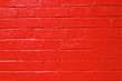 red painted shiny brick wall texture