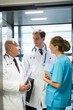 © WavebreakMediaMicro - Doctors and surgeon interacting with each other in elevator