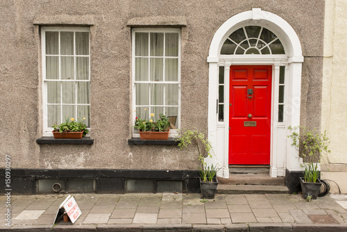 Facade Of British Traditional House With Grey Walls Red