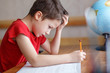 © sakkmesterke - Sad little boy depressed while doing homework