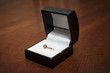 a ring box with a diamond engagement ring in it