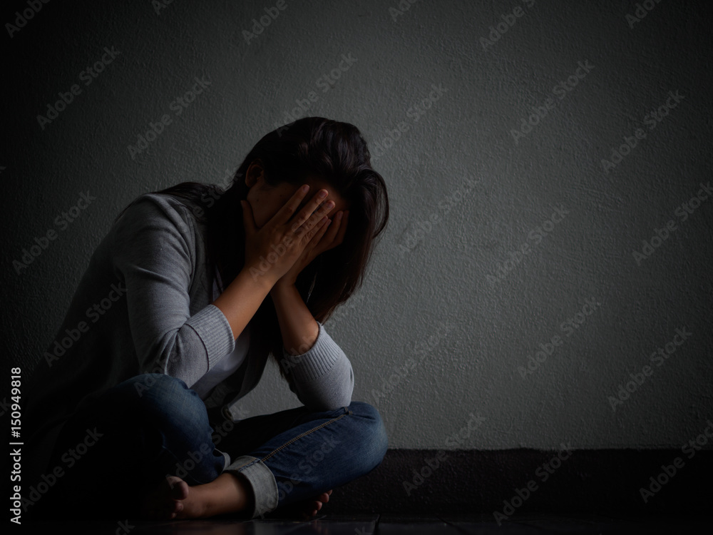sad woman hug her knee and cry. Sad woman sitting alone in a empty room ...